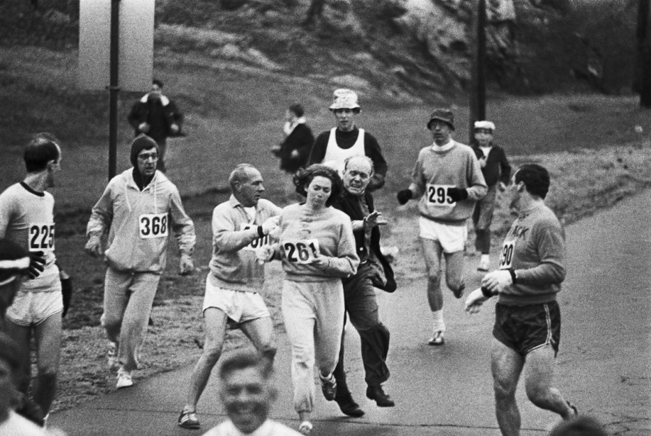 1967. Boston marathon organizers trying to stop Kathrine Switzer but she kept running.